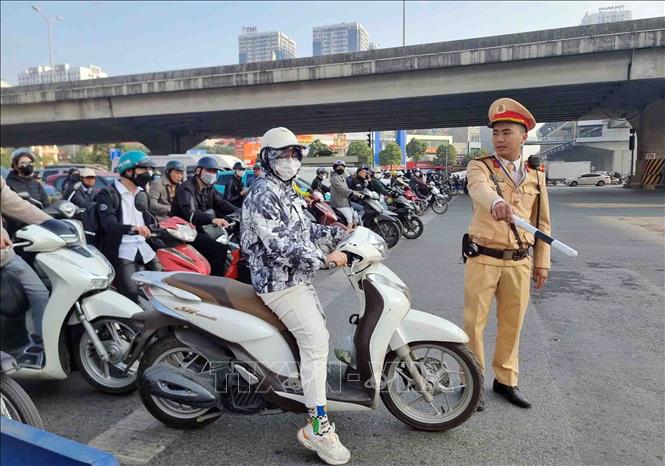 Một trường hợp vi phạm lỗi không chấp hành đèn tín hiệu giao thông bị lực lượng cán bộ, chiến sĩ đội CSGT số 7 dừng xe, kiểm tra và xử lý. Ảnh: Phạm Kiên/TTXVN